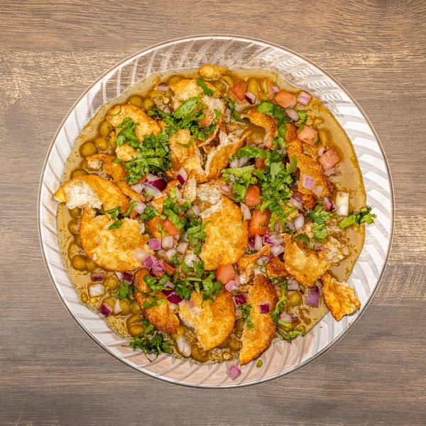 Dosa Spot's Indian chaat with crispy fried bread, chickpeas, onions, tomatoes, and cilantro.