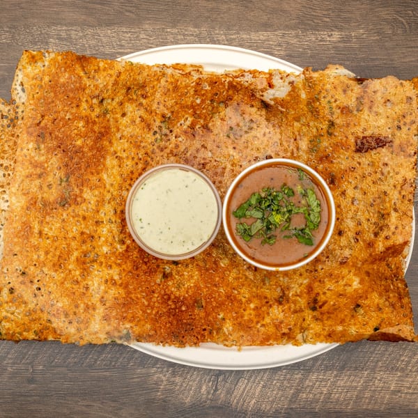 Crispy Dosa Spot dosa with two dipping sauces, one green and one brown with herbs.